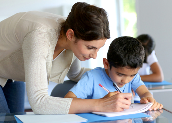 classroom teacher assisting student