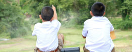 Image of two students looking into the distance